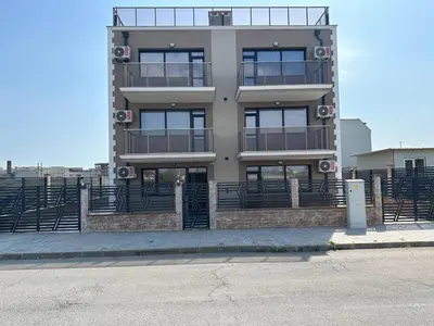 a tall building with a lot of windows at Studios and Apartments Pomorie in Pomorie