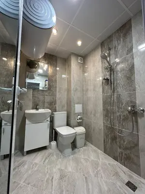 a bathroom with a toilet and a sink and a shower at Studios and Apartments Pomorie in Pomorie