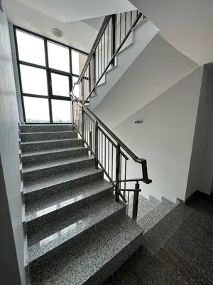 a staircase in a building with a large window at Studios and Apartments Pomorie in Pomorie