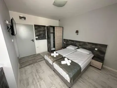 a bedroom with a bed with two white bows on it at Studios and Apartments Pomorie in Pomorie