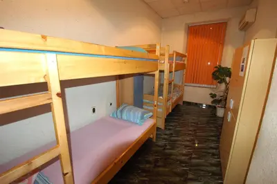 a room with three bunk beds and a hallway at Yo Ho Hostel in Varna City