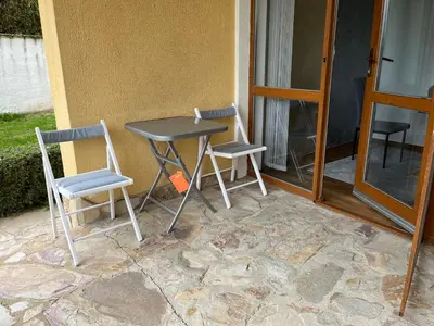 a table and two chairs sitting on a patio at EGGO APARTMENT - Oasis Beach Apartments Kamchia in Dolen Bliznak
