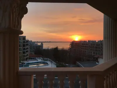 a sunset from the balcony of a building at Stylish Sea View Apartment 3 Min to Beach Balcony & Comfort in Pomorie