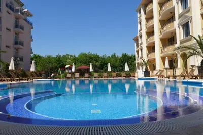 a large swimming pool in front of a building at Stylish Sea View Apartment 3 Min to Beach Balcony & Comfort in Pomorie