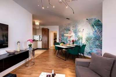 a living room with a couch and a table at Stylish Sea View Apartment 3 Min to Beach Balcony & Comfort in Pomorie