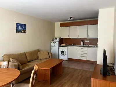 a living room with a couch and a kitchen at GT Green Fort Beach Apartments in Sunny Beach