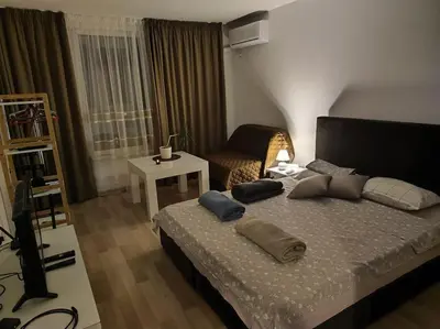 a bedroom with a bed with pillows on it at Sea apartment Lazur - next to the beach in Burgas City