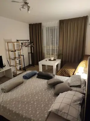 a bedroom with a large bed with pillows on it at Sea apartment Lazur - next to the beach in Burgas City