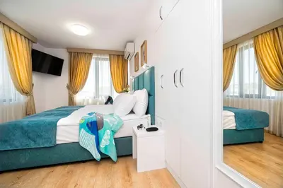 a hotel room with a bed and a mirror at Електра Апарт Бургас Electra Apart Burgas Elektra Bourgas in Burgas City