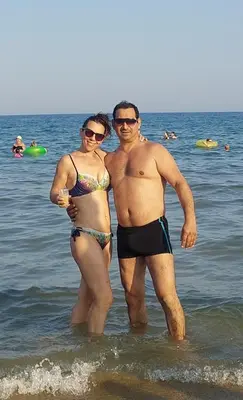 a man and woman standing in the water at the beach at Dream Cascadas - Слънчев бряг in Sunny Beach