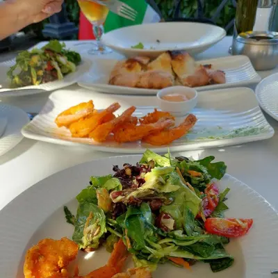 a white table with plates of food on it at Dream Cascadas - Слънчев бряг in Sunny Beach