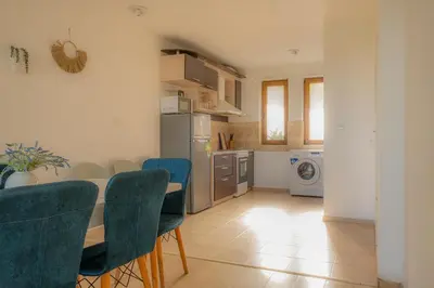 a kitchen and dining room with a table and chairs at Indigo Villas in Pismenovo