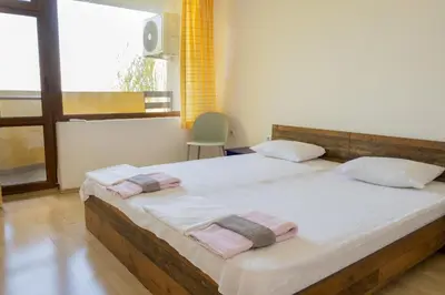 a bedroom with two beds with towels on them at Indigo Villas in Pismenovo