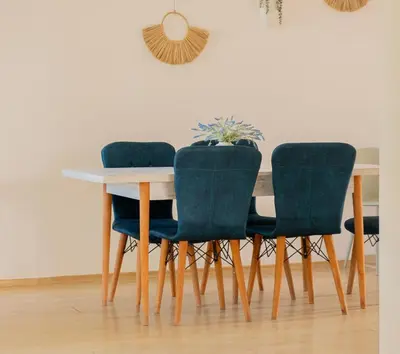 a dining room table with four chairs and a table at Indigo Villas in Pismenovo