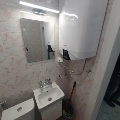 a bathroom with a sink and a mirror at Apartment Voivoda in Varna City