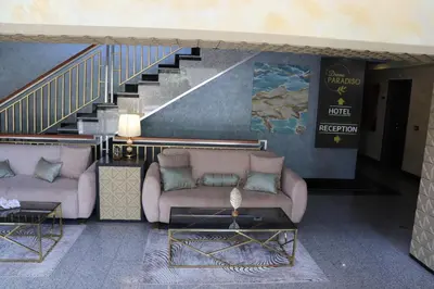 a living room with two couches and a staircase at Sea View Private Studio Paradiso B 508 in Nesebar