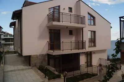 a white building with balconies on the side of it at Вила Дафни - Villa Dafni in Sozopol