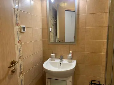 a bathroom with a sink and a mirror at Sozopoli Hills Apartment А4 in Sozopol