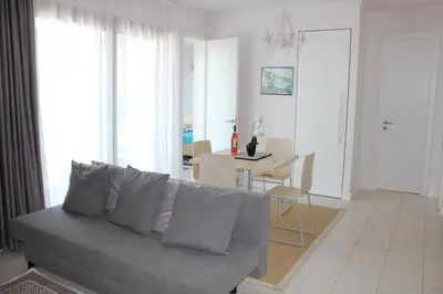 a living room with a couch and a dining room at Private Apartments in Yoo Bulgaria Complex in Obzor