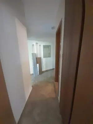 an empty room with a hallway with white walls at YASSEN APARTMENT CLOSE TO SEA And Central in Sunny Beach