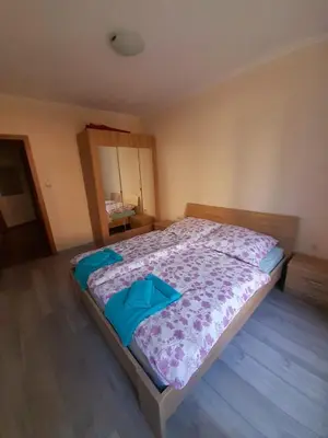 a bedroom with a bed with blue pillows on it at YASSEN APARTMENT CLOSE TO SEA And Central in Sunny Beach