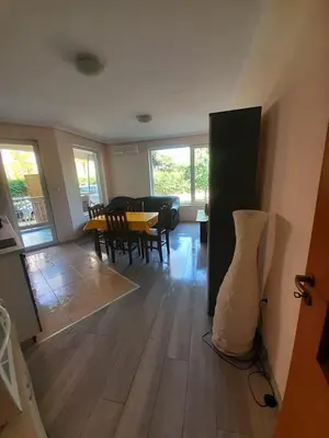 a living room with a table and chairs at YASSEN APARTMENT CLOSE TO SEA And Central in Sunny Beach