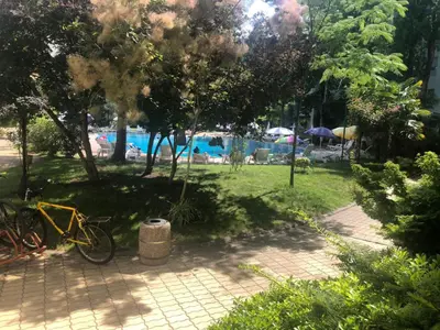 a bike parked in a park next to a swimming pool at YASSEN APARTMENT CLOSE TO SEA And Central in Sunny Beach