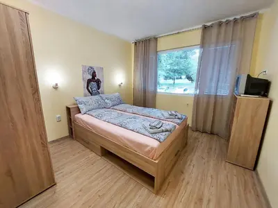 a small bedroom with a bed and a window at Апартамент за гости, ж.к. Зорница , бл.9 in Burgas City