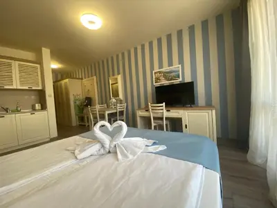 a bedroom with a bed with two white swans at PANORAMA BAY 20 Fancy Studio in Sveti Vlas