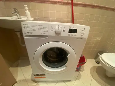a washing machine in a bathroom next to a toilet at ROYAL BAY 6 Sea View Apartment in Sveti Vlas