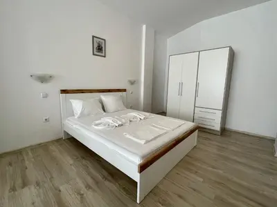 a white bedroom with a bed and a mirror at Sveti Vlas - Central Beach Studio by Flat Mаnаger in Sveti Vlas