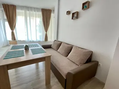 a living room with a couch and a table at Sveti Vlas - Central Beach Studio by Flat Mаnаger in Sveti Vlas