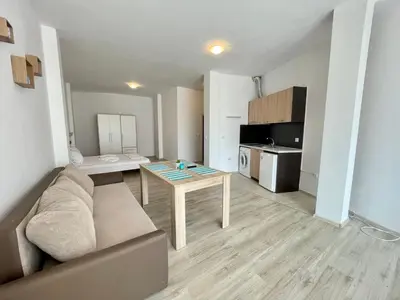 a living room with a couch and a table at Sveti Vlas - Central Beach Studio by Flat Mаnаger in Sveti Vlas