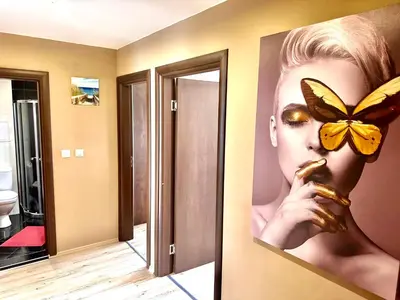 a bathroom with a picture of a woman with a butterfly on the wall at One Bedroom Private Apartment Paradiso B 501 in Nesebar
