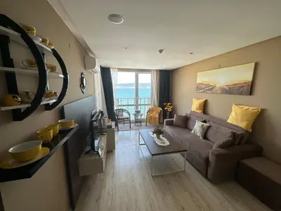 a living room with a couch and a table at One Bedroom Private Apartment Paradiso B 501 in Nesebar