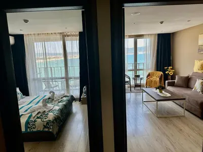 a bedroom with a bed and a living room at One Bedroom Private Apartment Paradiso B 501 in Nesebar