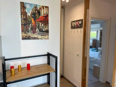 a room with a table with a painting on the wall at Panoramic apartment in Varna with underground parking in Varna City