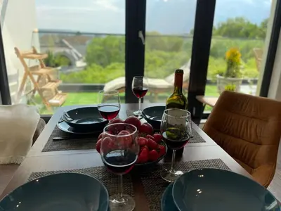 a table with glasses of wine and a bowl of fruit at Panoramic apartment in Varna with underground parking in Varna City