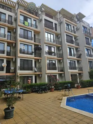 an apartment building with a pool in front of it at SannyBeach AmberBeach Apartment Bulgaria A14-1 in Sunny Beach