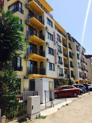 a large apartment building with cars parked in front of it at SannyBeach AmberBeach Apartment Bulgaria A14-1 in Sunny Beach