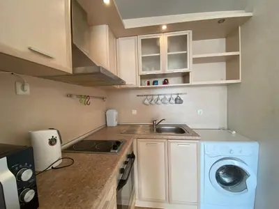 a small kitchen with a sink and a washing machine at RUTLAND BEACH C8 Two Bedroom Apartment Ravda in Ravda