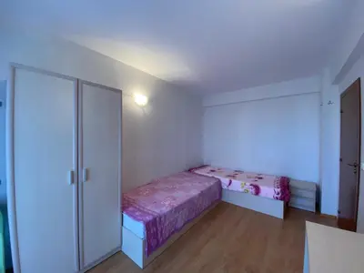 a small bedroom with a bed and a closet at RUTLAND BEACH C8 Two Bedroom Apartment Ravda in Ravda