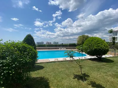 a large swimming pool in a yard with trees at RUTLAND BEACH C8 Two Bedroom Apartment Ravda in Ravda