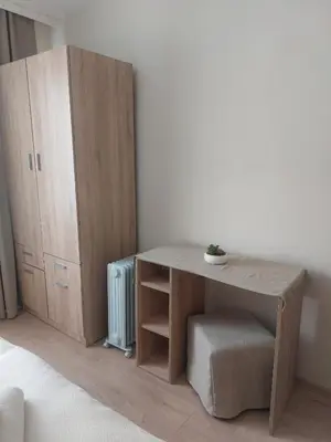 a room with a wooden table and a cabinet at Deni's Apartment by the sea – Burgas in Burgas City