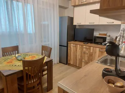 a kitchen with a table and a dining room at Deni's Apartment by the sea – Burgas in Burgas City