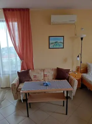 a living room with a couch and a table at Студио Слънчево утро in Burgas City