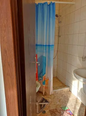 a bathroom with a shower with a toilet and a sink at Студио Слънчево утро in Burgas City