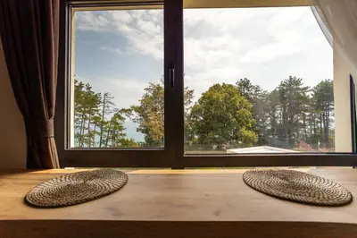 two circular objects on the floor in front of a window at Open Sea Panorama Residence in Obzor