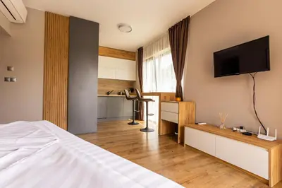 a bedroom with a bed and a flat screen tv at Open Sea Panorama Residence in Obzor