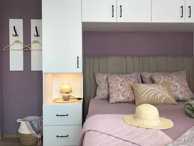 a bedroom with a bed with a hat on it at AMORE Obzor in Obzor